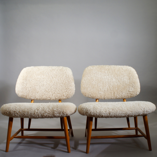 Alf Svensson for Ljungs Industrier/Bra Bohag, Swede. ¨ Te-ve¨. A pair of easy chairs in beech, new upholstered in sheep skin. 62x60, height 70. Sit height 35 cm. Available in different colours. 19000 SEK/pair or 10000 each.
