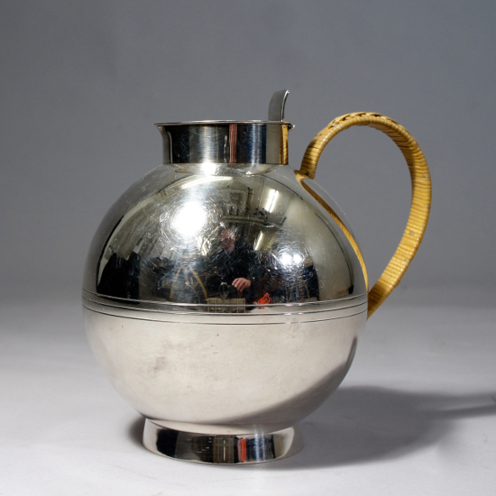 Sylvia Stave for C.G. Hallberg, Sweden. Jug in silver plated alpacka with cane covered handle. Designed 1933. Height 17 cm. Silver kanna. Hallbergs, 30-tal, Wigerdals Värld