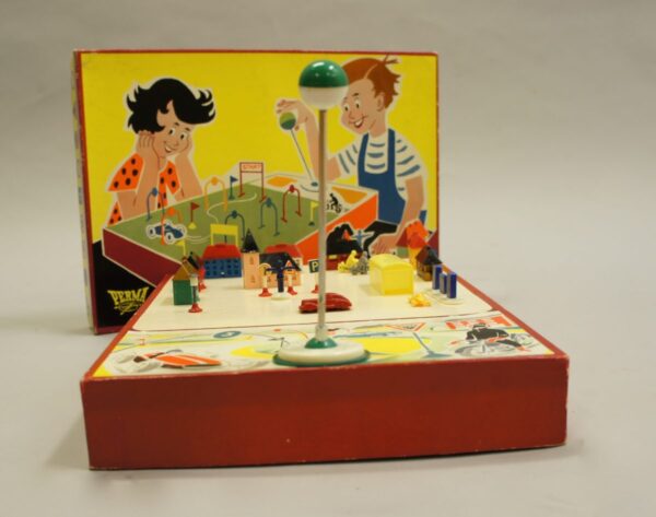 Driving school toy containing a magnetic driven car or motorbike with houses, road signs etc. Perma, Wester Germany 1950. Rare and good condition, parts missing.