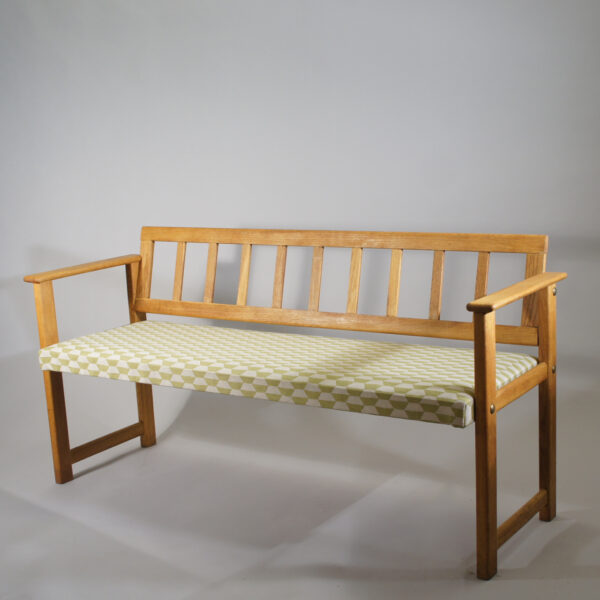 Sofa in oak with seat covered in fabric. Maker unknown. Lenght 140 cm.