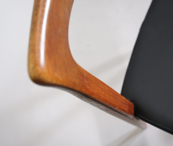 Four side chairs in teak with seat cover in leather imitation.