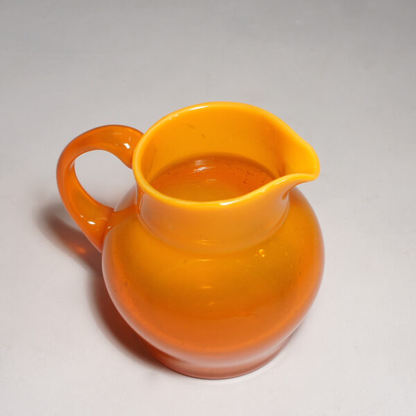 Erik Höglund for Kosta. Signed jug in orange glass.