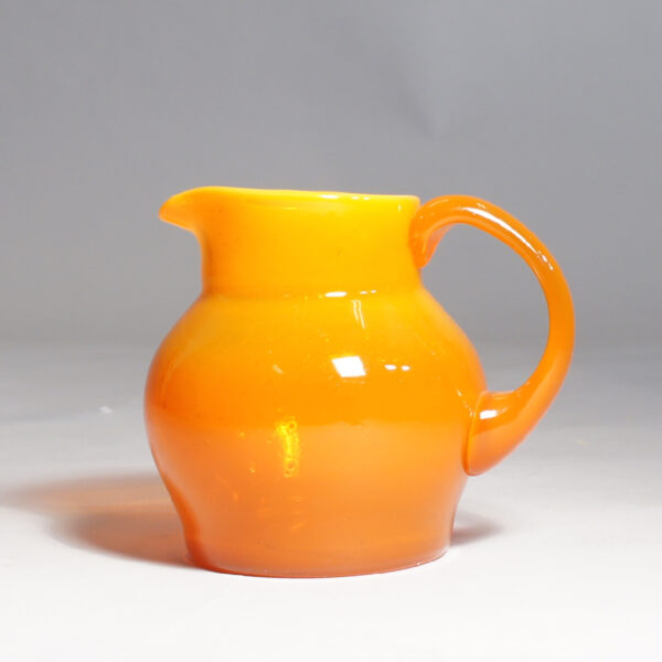 Erik Höglund for Kosta. Signed jug in orange glass.