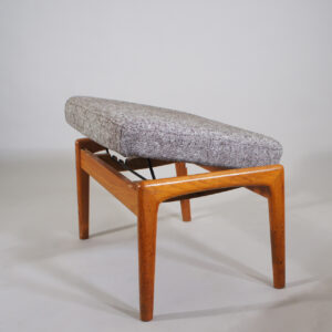 Folke Ohlsson for Dux, Sweden. Ottoman in teak with new upholstered seat in wool fabric.