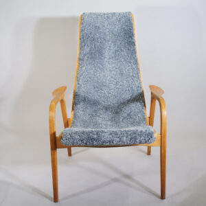 Yngve Ekström for Swedese, Sweden ."Lamino". Easy chair in oak with new sheep skin.