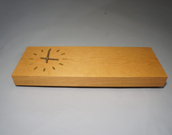 Wall clock in oak with details in brass.Väggklocka i ek wigerdals vintage