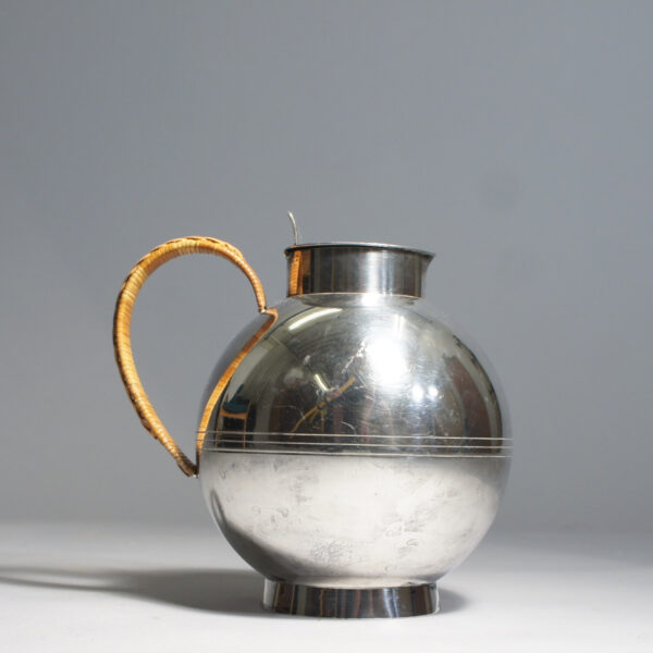 Sylvia Stave for C.G. Hallberg, Sweden. Jug in silver plated alpacka with cane covered handle. Designed 1933. Silverkanna Wigerdals.com