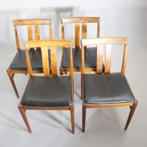 Four side chairs in rosewood/palisander with seats in leather. Matstolar i jakaranda sits i svart läder