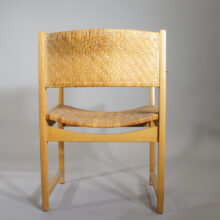 A pair of arm chairs in oak and rattan. Wigerdals Värld