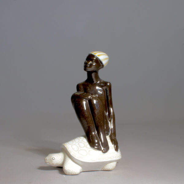 Mari Simmulson for Upsala-Ekeby. Figurine. Boy on turtle. Pojke på sköldpadda Wigerdals Värld