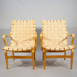 Bruno Mathsson for Karl Mathsson. "Eva". A pair of arm chairs in beech with new webbing in leather. Karmstol i bok med sadelgjord i läder Wigerdals