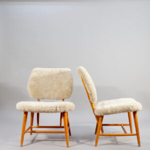A pair of easy chairs in beech and sheepskin. fåtöljer i fårskinn Wigerdals