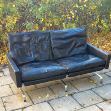 Christansen,Denmark. Pk31-2 2 sit sofa in black leather and legs in steel. Wigerdal.com