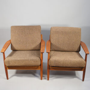 A pair of easy chairs in teak with wool fabric.