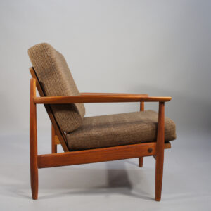 A pair of easy chairs in teak with wool fabric.