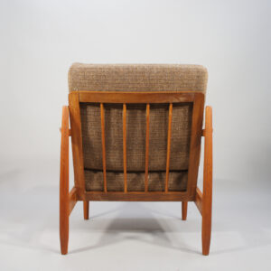 A pair of easy chairs in teak with wool fabric.