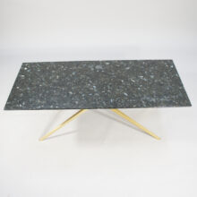 A 1950's coffee table in black granite and brass. d.