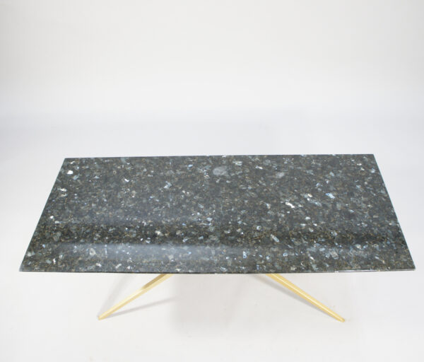 A 1950's coffee table in black granite and brass.