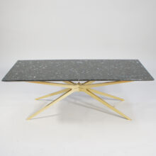 A 1950's coffee table in black granite and brass.