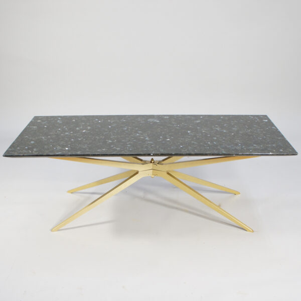 A 1950's coffee table in black granite and brass.