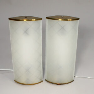 A pair of 1940-50's wall lamps in brass and glass.