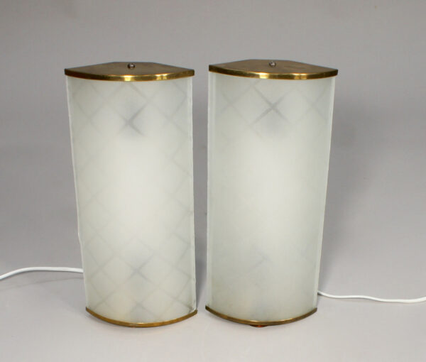 A pair of 1940-50's wall lamps in brass and glass.