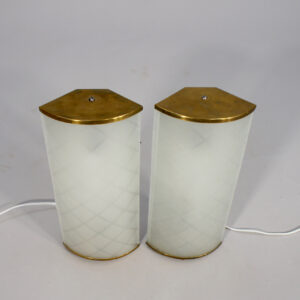 A pair of 1940-50's wall lamps in brass and glass.