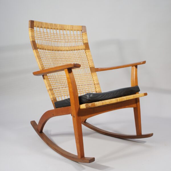 Hans Olsen for Juul Kristensen. 1950's rocking chair in teak and rattan with cushin in leather.