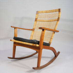 Hans Olsen for Juul Kristensen. 1950's rocking chair in teak and rattan with cushin in leather.