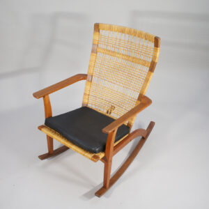 Hans Olsen for Juul Kristensen. 1950's rocking chair in teak and rattan with cushin in leather.