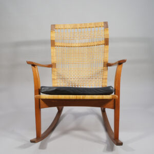 Hans Olsen for Juul Kristensen. 1950's rocking chair in teak and rattan with cushin in leather.