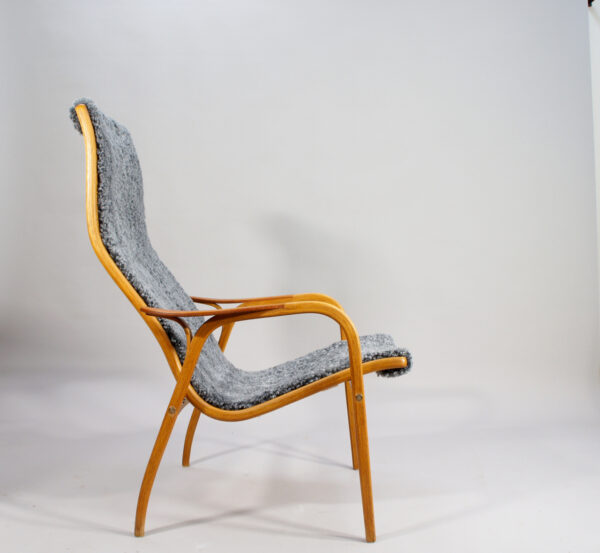 Yngve Ekström for Svedese, Sweden. "Lamino" 1950's easy chair in oak, teak and reupholstered in grey sheep skin.