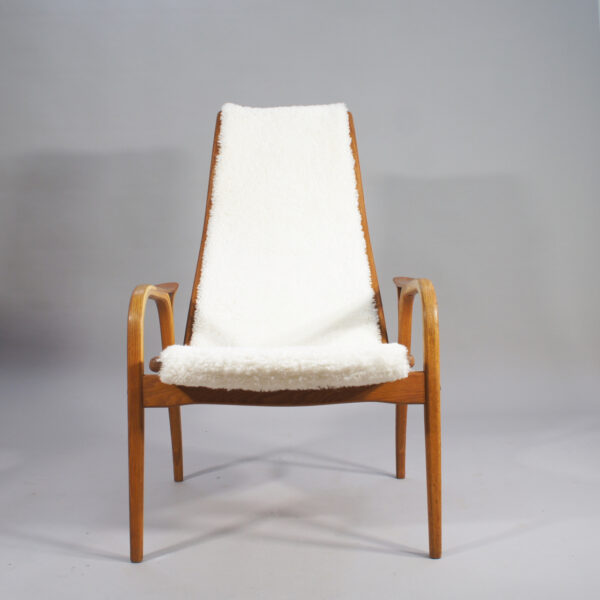 Yngve Ekström for Svedese, Sweden. "Lamino" 1950's easy chair in oak, teak and reupholstered in white sheep skin.