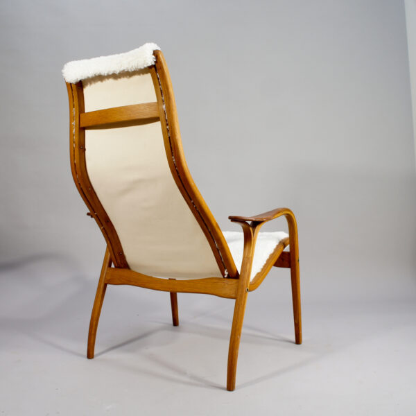 Yngve Ekström for Svedese, Sweden. "Lamino" 1950's easy chair in oak, teak and reupholstered in white sheep skin.