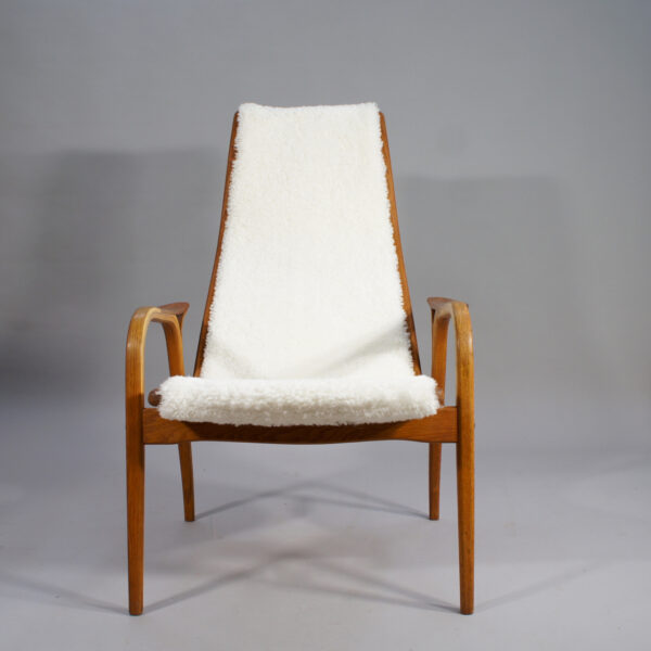 Yngve Ekström for Svedese, Sweden. "Lamino" 1950's easy chair in oak, teak and reupholstered in white sheep skin.