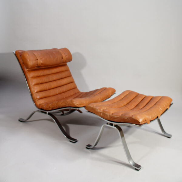 Ari. Easy chair in steel and leather with ottoman by Arne Norell, Sweden.