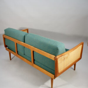 Peter Hvidt & Orla Mølgaard for France & Son, Denmark. 1950's sofa mod 453 in teak, rattan with new upholtered seating. Folding arm rests.