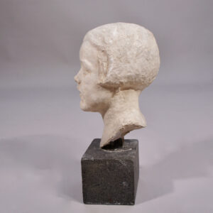 Girls' head sculpture in plaster on a base in stone.. .