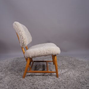 Alf Svensson for Dux, Sweden. "TeVe". Easy chair in beech with lamb skin. "TeVe"-stolen av Alf Svensson för Dux.