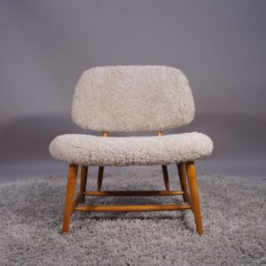 Alf Svensson for Dux, Sweden. "TeVe". Easy chair in beech with lamb skin. "TeVe"-stolen av Alf Svensson för Dux.