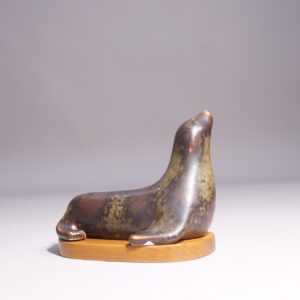 Gunnar Nylund for Rörstrand. 1950's signed seal in stoneware on base in wood. Sälfigurin av Gunnar Nylund