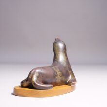 Gunnar Nylund for Rörstrand. 1950's signed seal in stoneware on base in wood. Sälfigurin av Gunnar Nylund