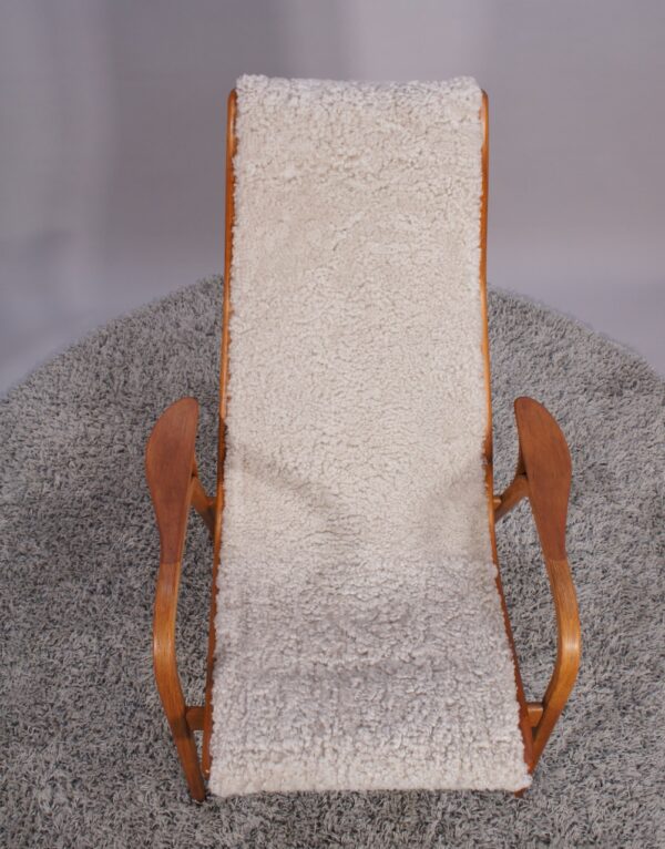 Yngve Ekström for Svedese, Sweden. “Lamino”. 1956 easy chair in oak and teak reupholstered in sheep skin.