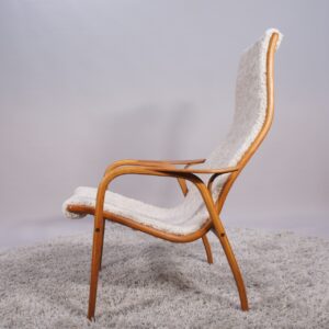 Yngve Ekström for Svedese, Sweden. “Lamino”. 1956 easy chair in oak and teak reupholstered in sheep skin.