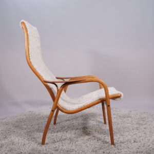 Yngve Ekström for Svedese, Sweden. “Lamino”. 1956 easy chair in oak and teak reupholstered in sheep skin.