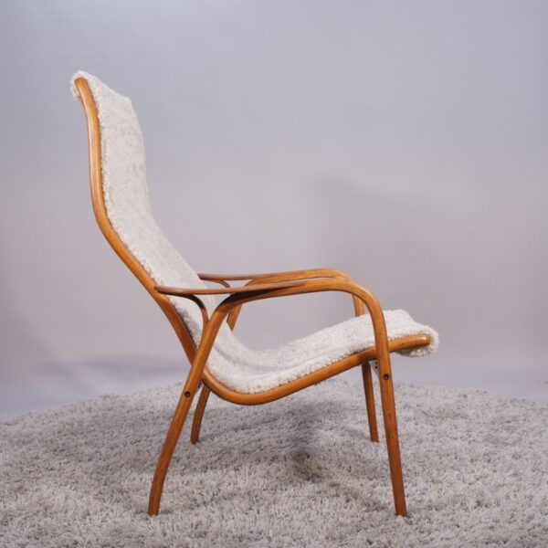 Yngve Ekström for Svedese, Sweden. “Lamino”. 1956 easy chair in oak and teak reupholstered in sheep skin.