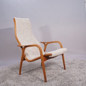 Yngve Ekström for Svedese, Sweden. “Lamino”. 1956 easy chair in oak and teak reupholstered in sheep skin.