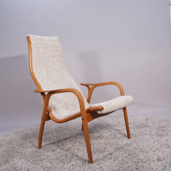 Yngve Ekström for Svedese, Sweden. “Lamino”. 1956 easy chair in oak and teak reupholstered in sheep skin.