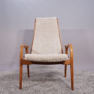 Yngve Ekström for Svedese, Sweden. “Lamino”. 1956 easy chair in oak and teak reupholstered in sheep skin.