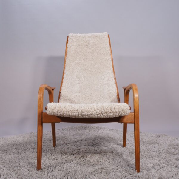 Yngve Ekström for Svedese, Sweden. “Lamino”. 1956 easy chair in oak and teak reupholstered in sheep skin.